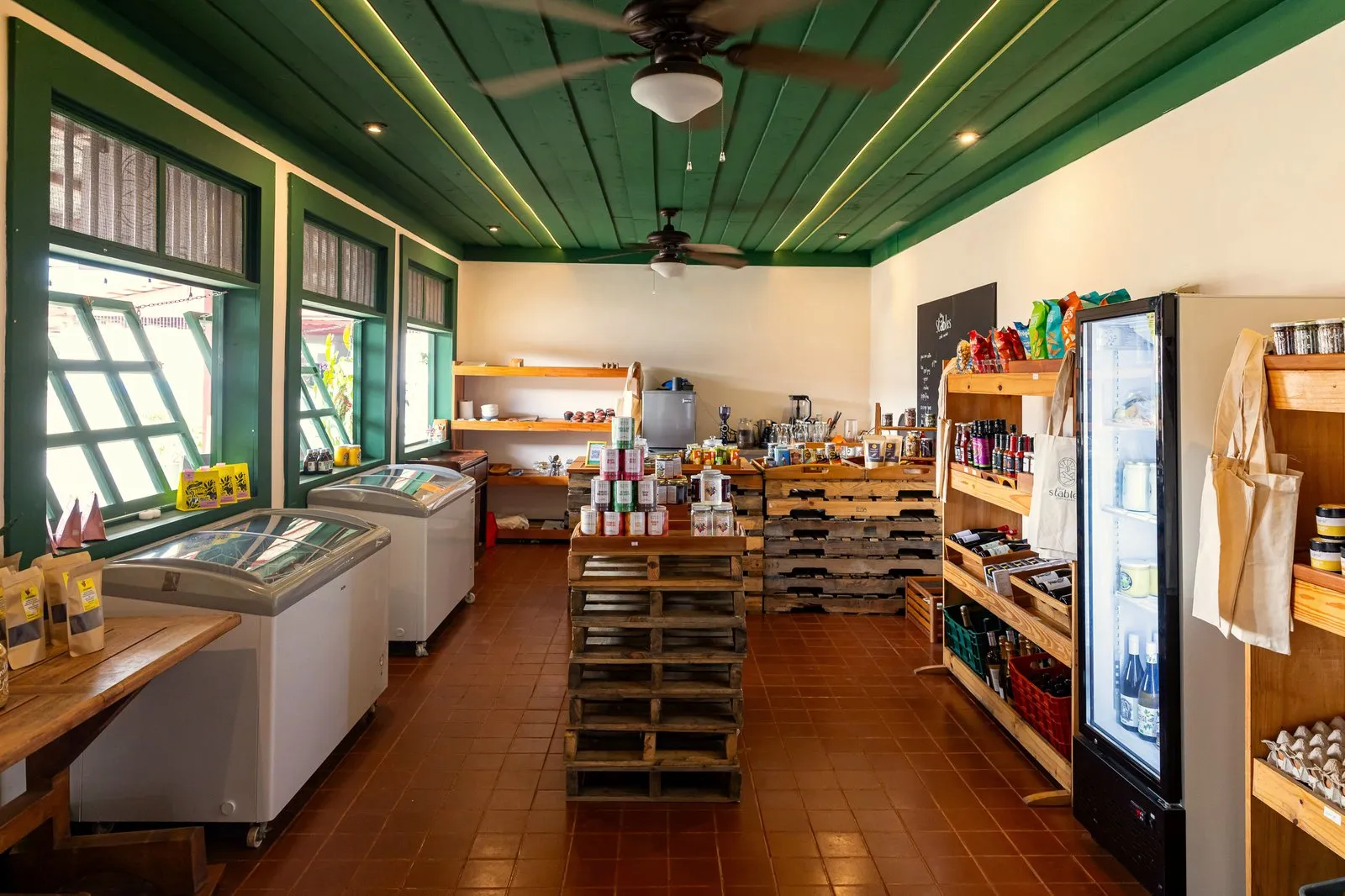 Inside The Stables Market: shelves stocked with organic products, artisanal goods, and local produce